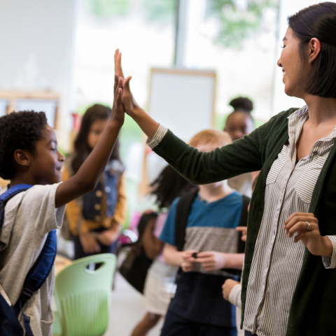 Teacher giving student a high five
